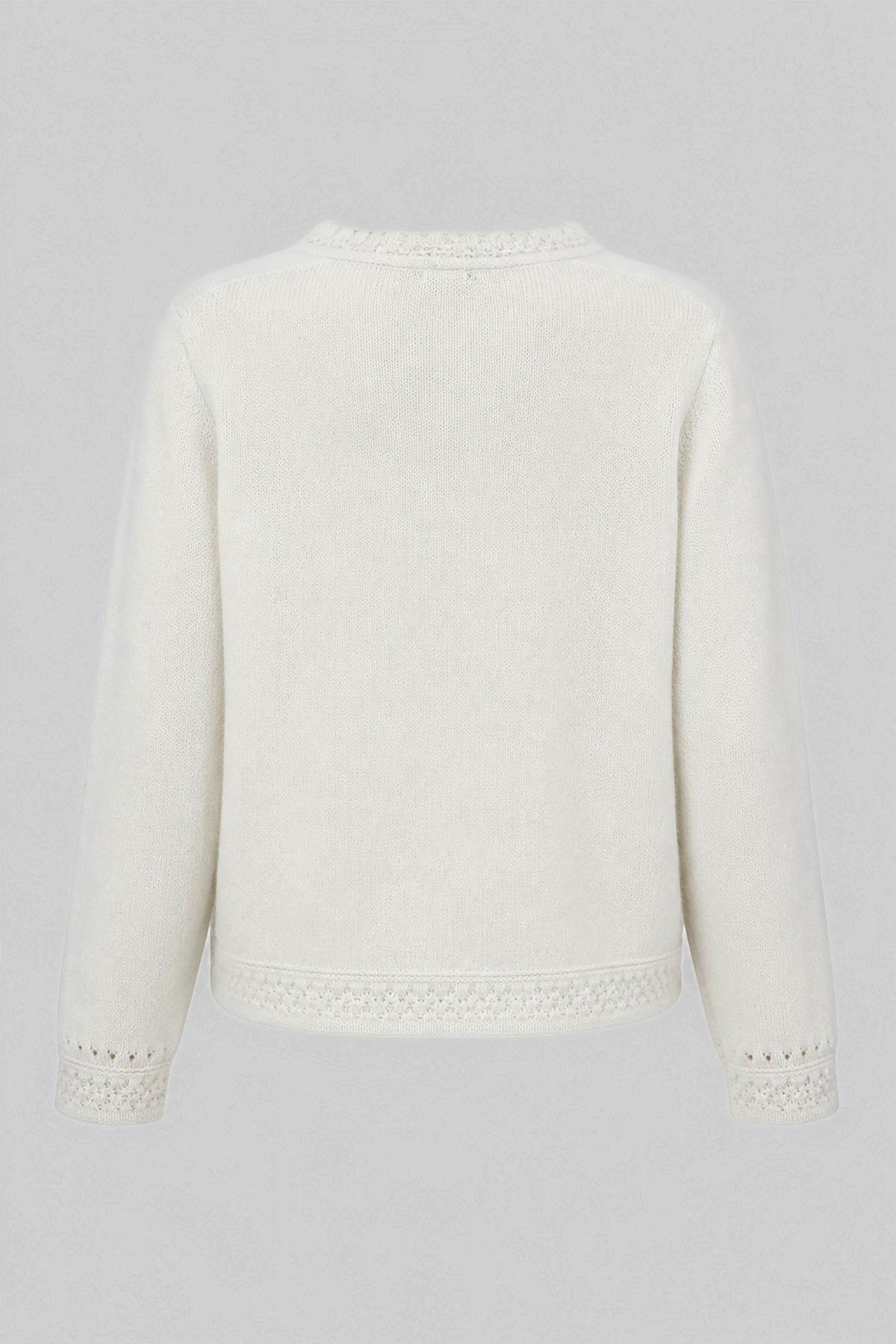 A delicate buttoned cardigan made of ecru alpaca wool and girl's wool.