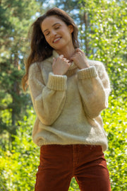 Knitted seamless oversized turtleneck sweater with roll-up cuffs, made of kid mohair and merino wool, beige