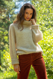 Knitted seamless oversized turtleneck sweater with roll-up cuffs, made of kid mohair and merino wool, beige