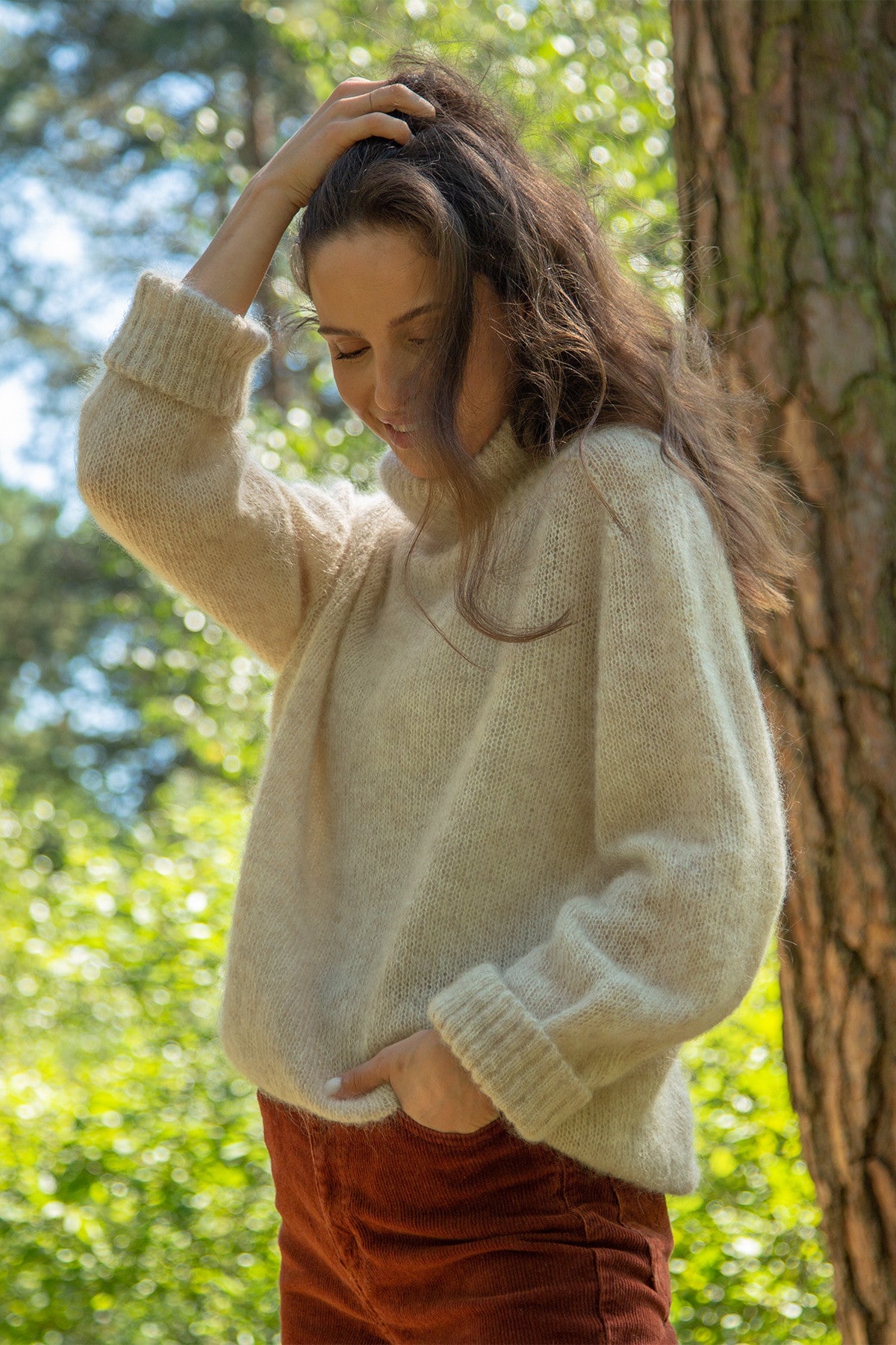 Knitted seamless oversized turtleneck sweater with roll-up cuffs, made of kid mohair and merino wool, beige