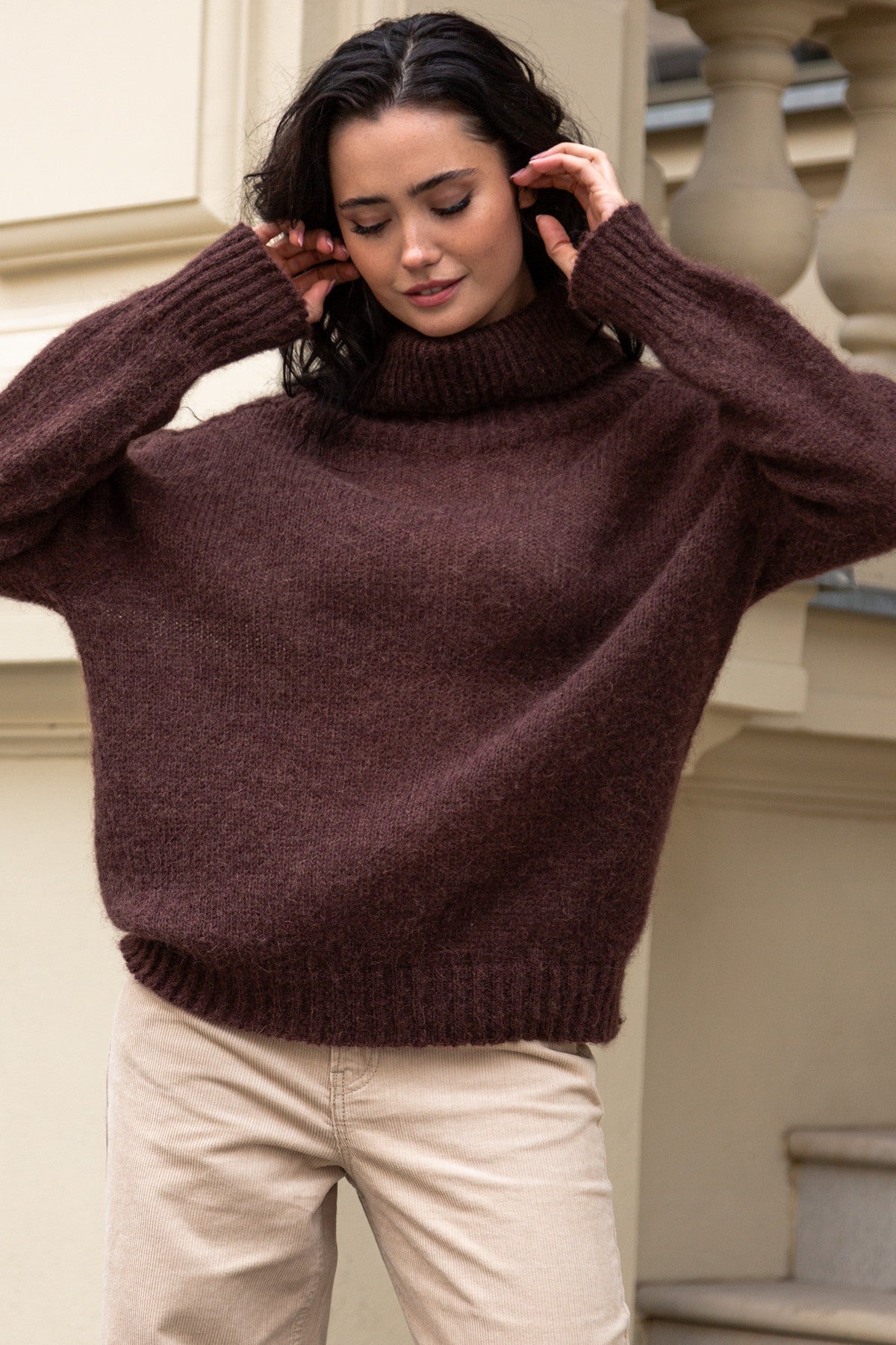 Knitted seamless oversized turtleneck sweater with roll-up cuffs, made of kid mohair and merino wool, brown
