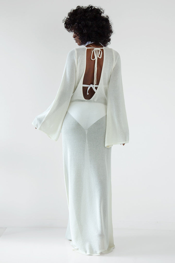 Long openwork dress with a neckline at the back made of ecru cotton