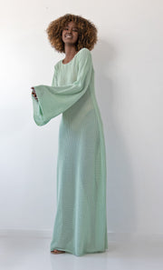 Long openwork dress with a neckline on the back made of pistachio cotton