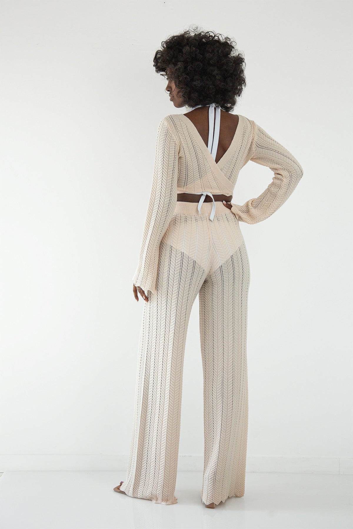 Set of long openwork trousers and a tied beige blouse