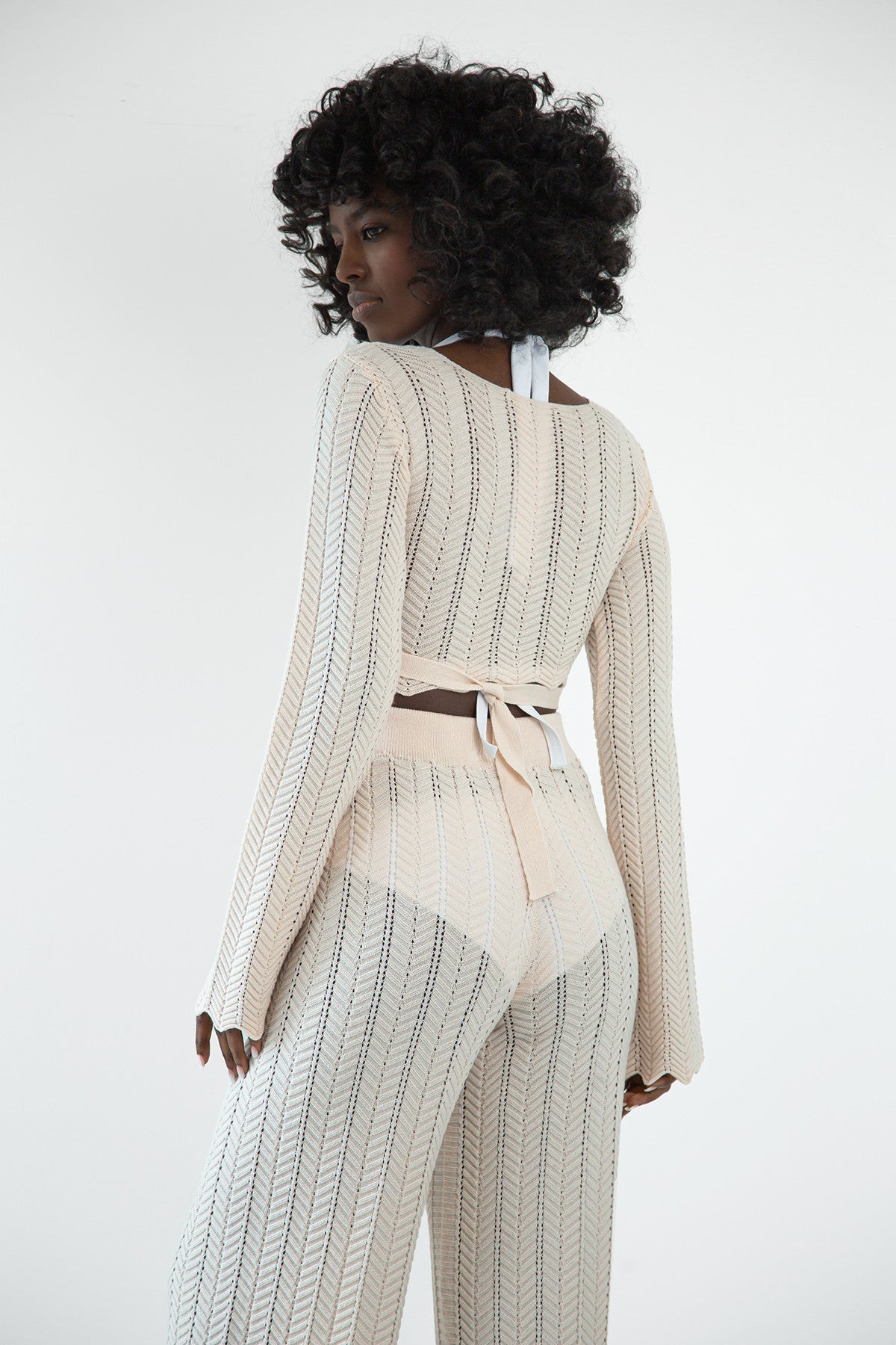 Set of long openwork trousers and a tied beige blouse