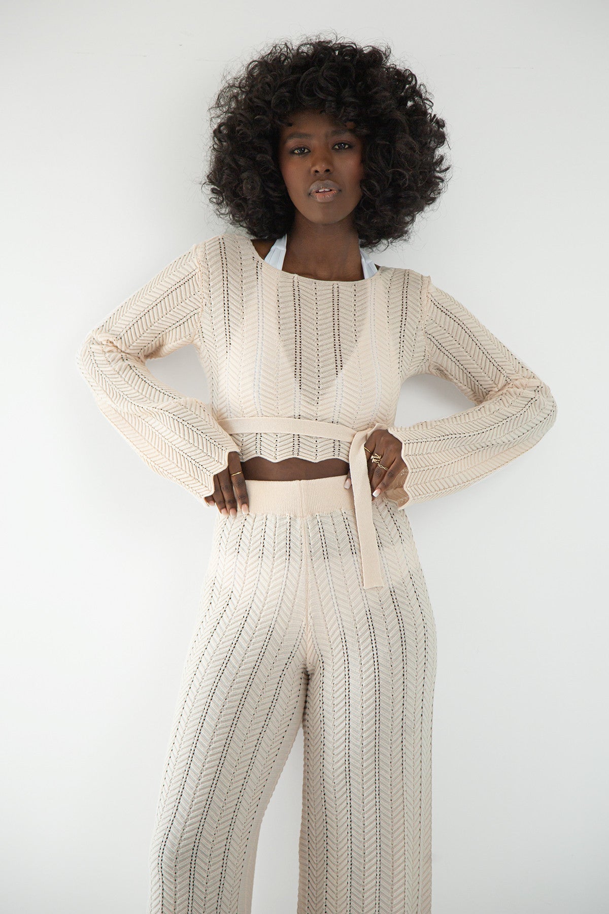 Set of long openwork trousers and a tied beige blouse