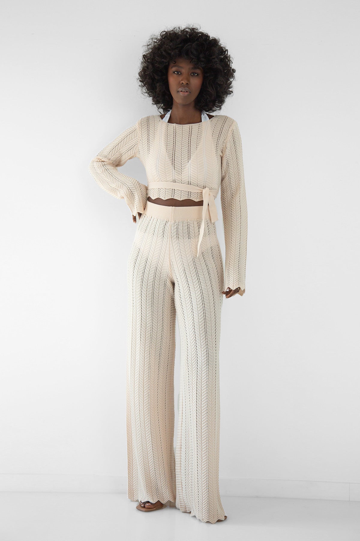 Set of long openwork trousers and a tied beige blouse