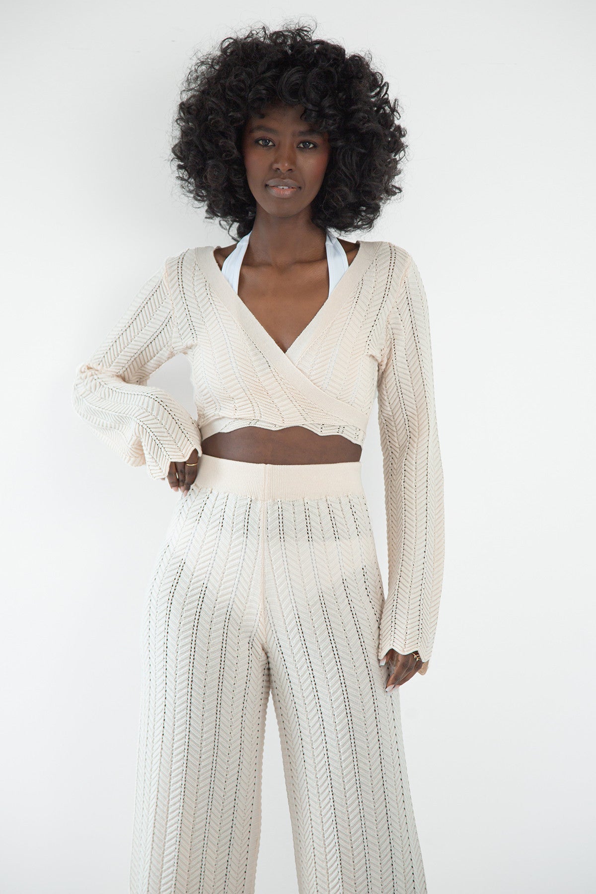 Set of long openwork trousers and a tied beige blouse