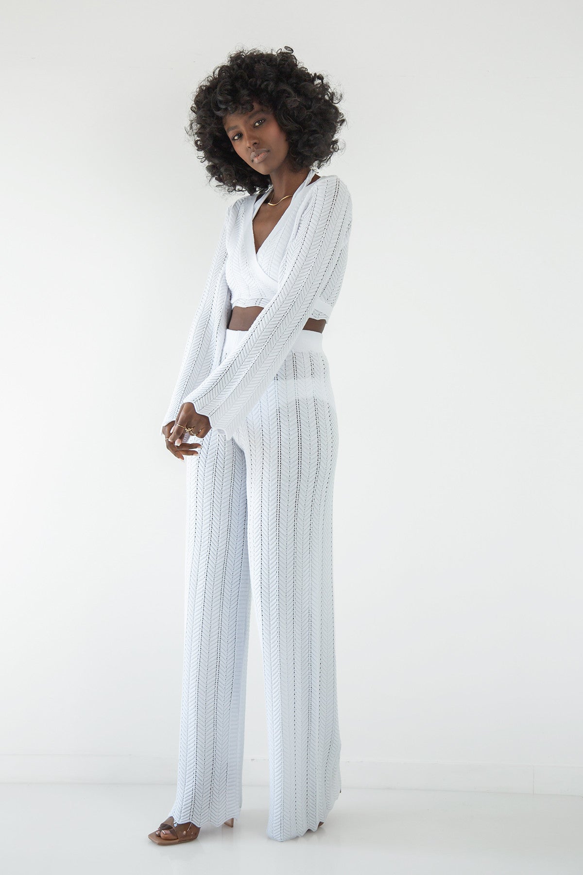 Set of long openwork trousers and a white tied blouse