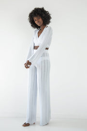 Set of long openwork trousers and a white tied blouse