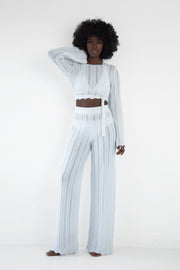 Set of long openwork trousers and a white tied blouse