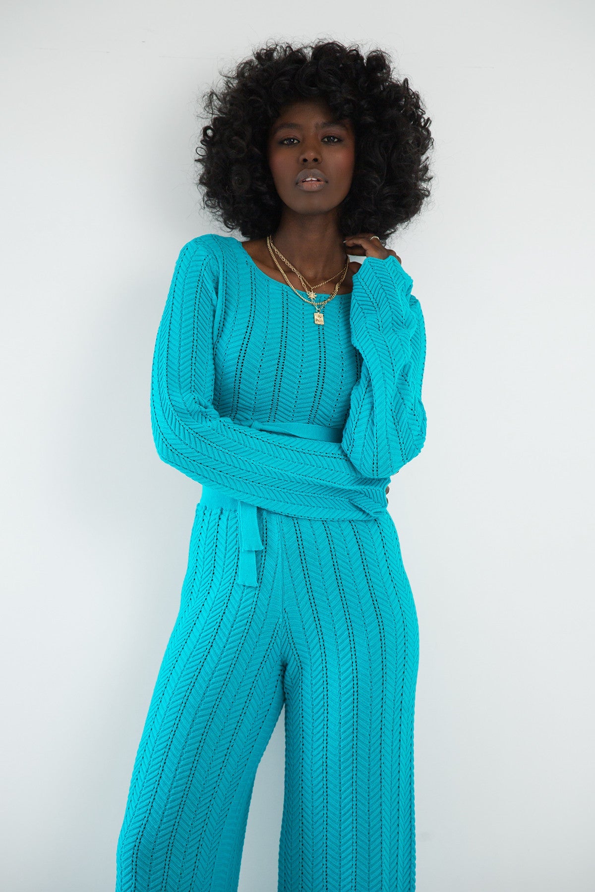 Set of long openwork trousers and a tied blouse in blue