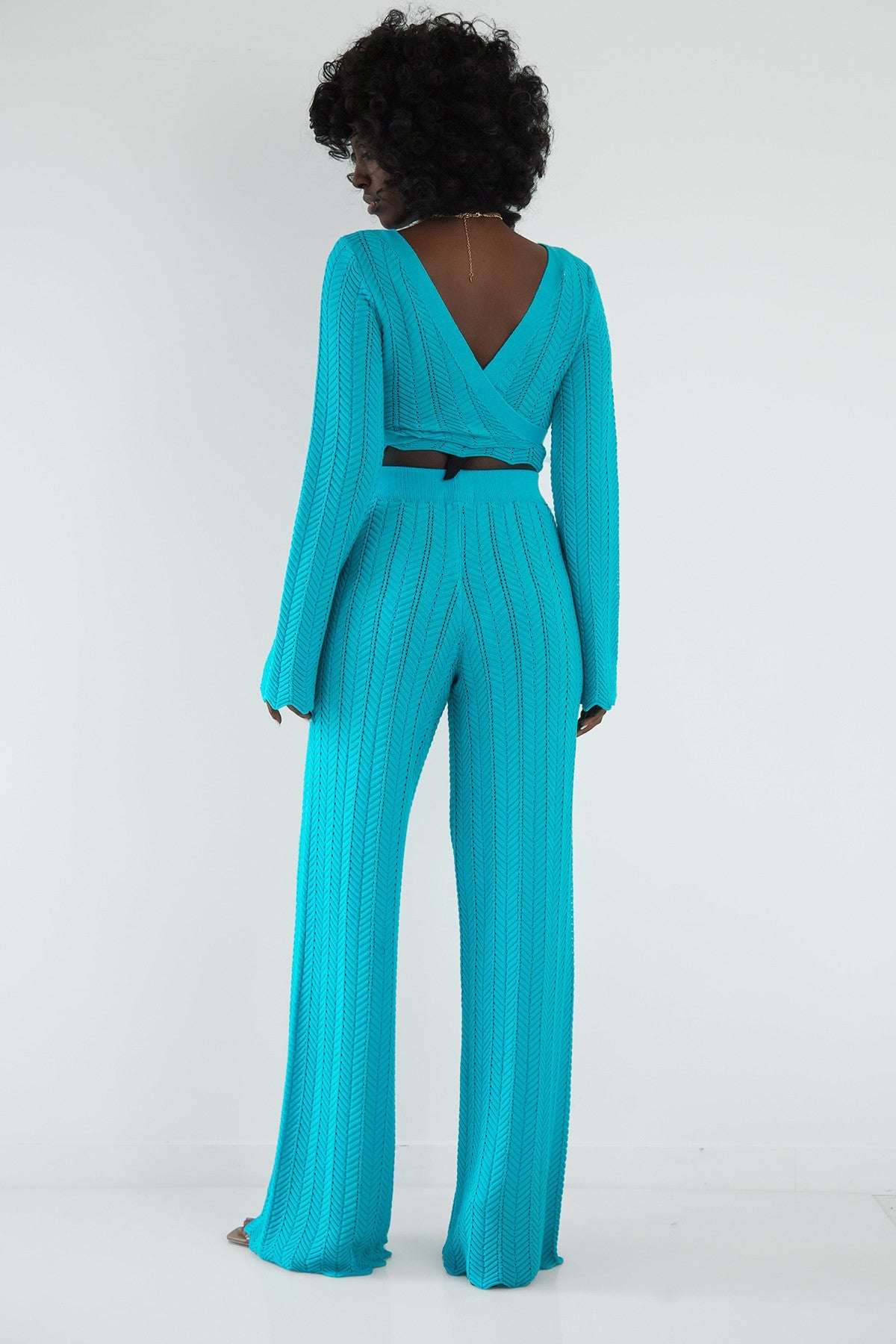 Set of long openwork trousers and a tied blouse in blue