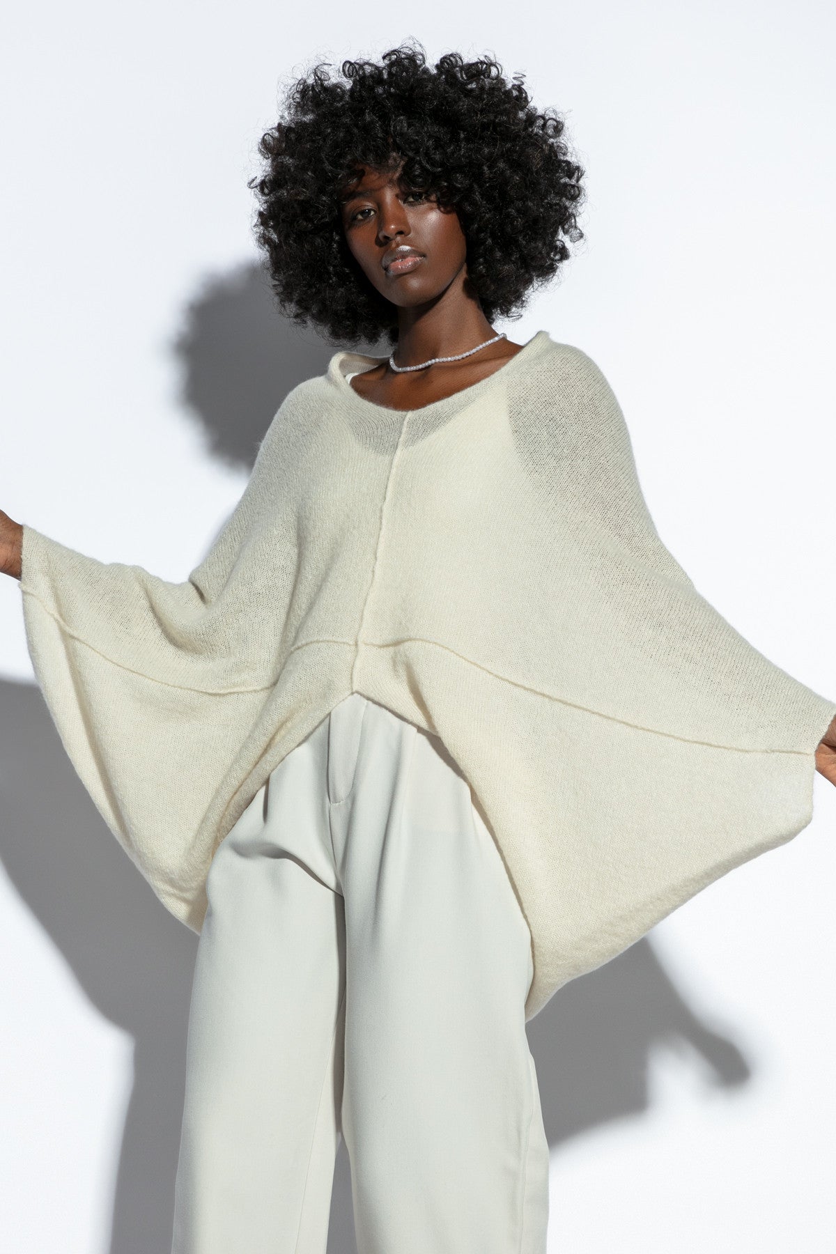 Loose, elegant ecru silk sweater overlay