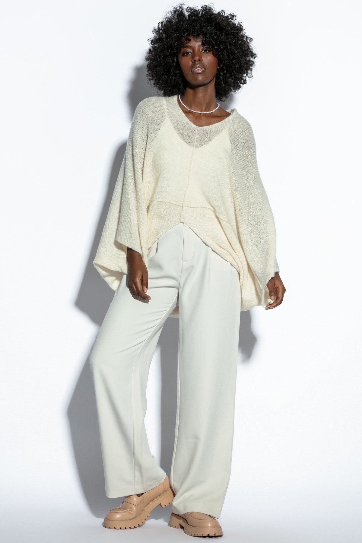 Loose, elegant ecru silk sweater overlay