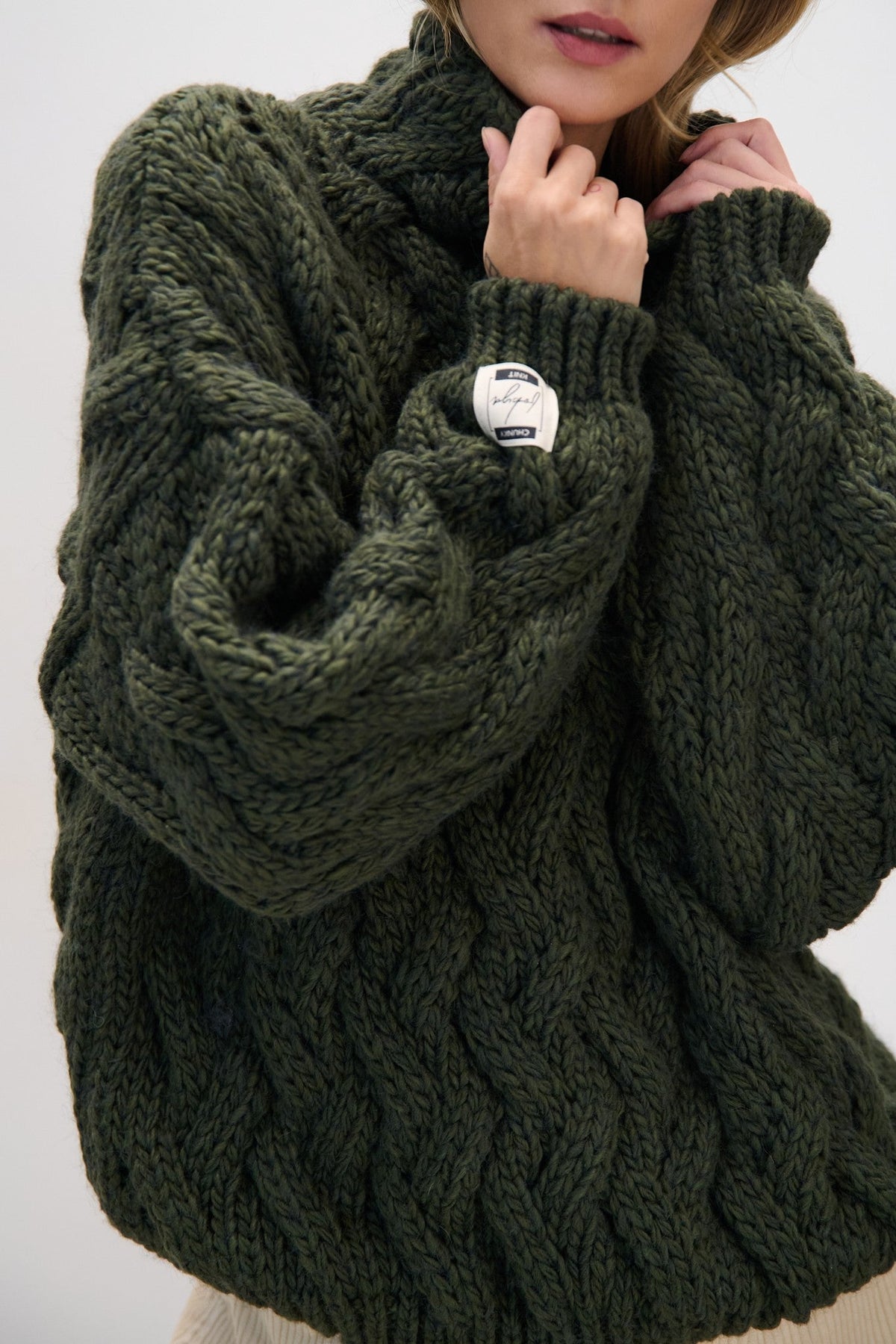 Thick woolen sweater with a cable knit, olive green