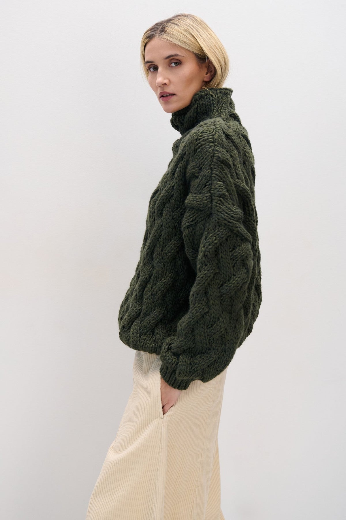 Thick woolen sweater with a cable knit, olive green